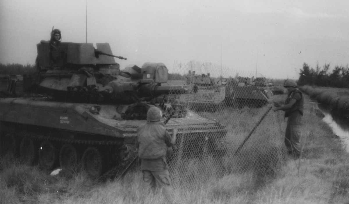 Tank crews from H Troop, 17th Cavalry, 198th Infantry Brigade of the Americal Division set up wire screens in front of their Sheridan Tanks in preparation of a night defensive position. The screens protect the vehicles from rifle-propelled grenades (RPGs) which detonate on contact. (USA Photo by Sgt. Thomas C. Elmer)