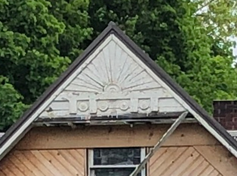 One of the few original decorative features of the Hartman House still visible is this sun-burst feature on the front gable of the home, May 2022.