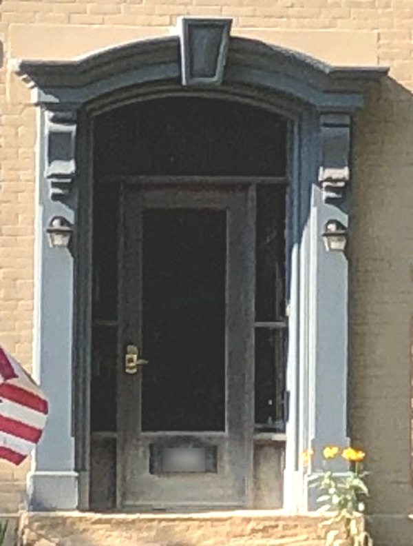 Detail of the hooded front door of the Stow House, 2022.