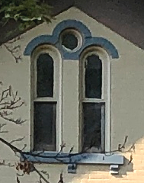 Detail of the double full-arched attic window on the Stow House, 2022.