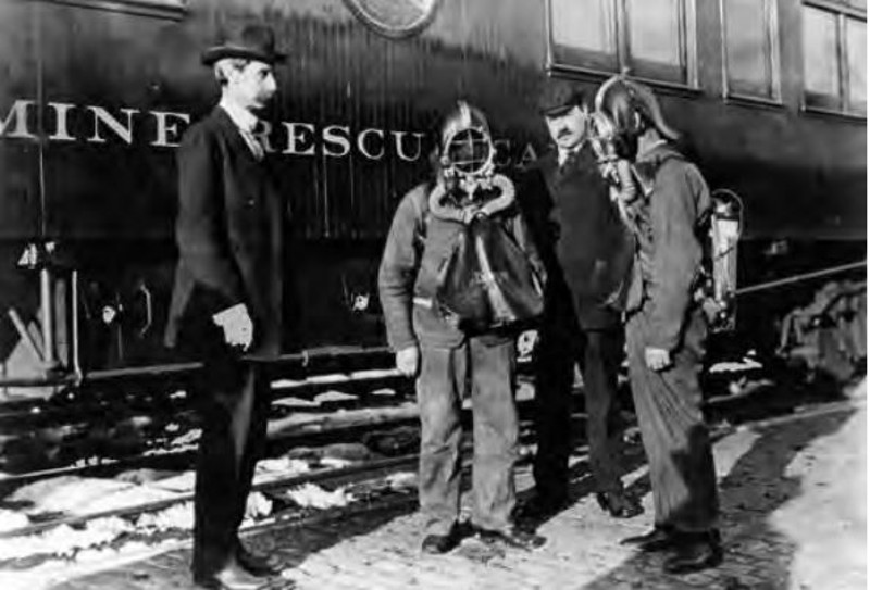 Miners being trained in front of mine rescue car, 1913.