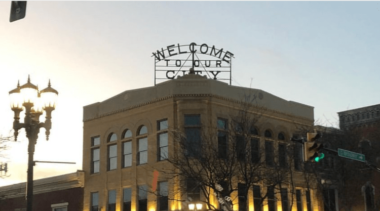 The modern "Welcome to Our City" sign atop the Alexander building in New Philadelphia, Ohio, 2023.
