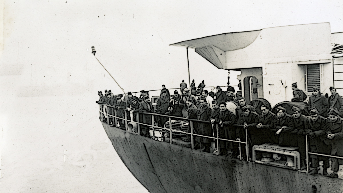 Altered image of American soldiers standing on the deck of a troop transport ship during World War Two.