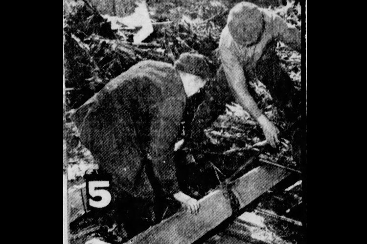 Two farmers trying to recover the body of a cow killed in the barn of Earl Conway, April 1940. (Source: newspapers.com)