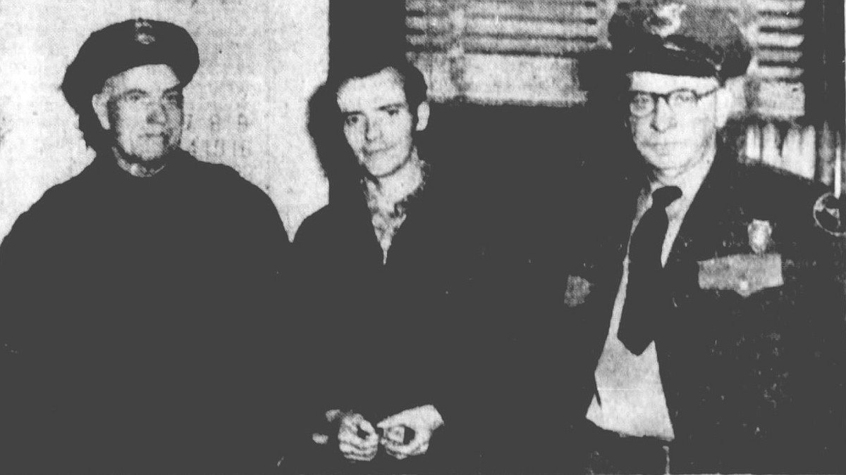 Newspaper photograph of Stewart Merryman in custody after the murder of Harvey Johnson, November 1954. (Source: newspapers.com)